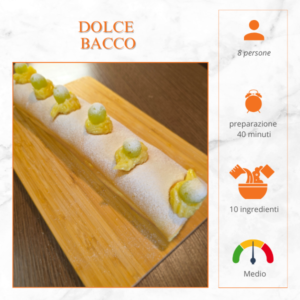 Dolce Bacco, rotolo farcito con crema e uva, decorato con zucchero a velo e crema pasticcera, servito su tagliere di legno.